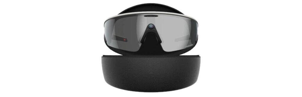 VR headset resting on a rounded charging dock, black with gray visor lenses and reflective surface