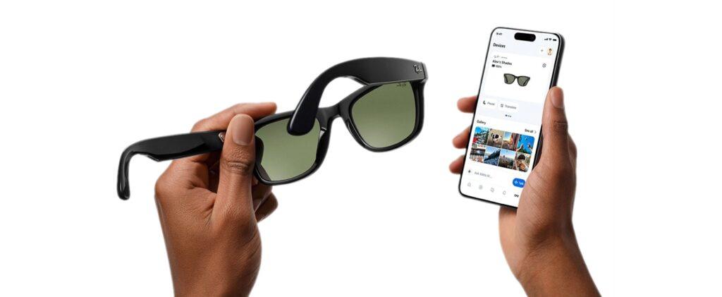 Hands hold black smart sunglasses while a smartphone shows the companion app screen for controlling the glasses, against a white background.